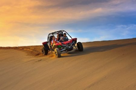 Drivers driving dune buddy in dubai desert