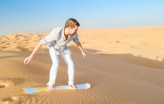 A man is surging on the Dubai Desert sand